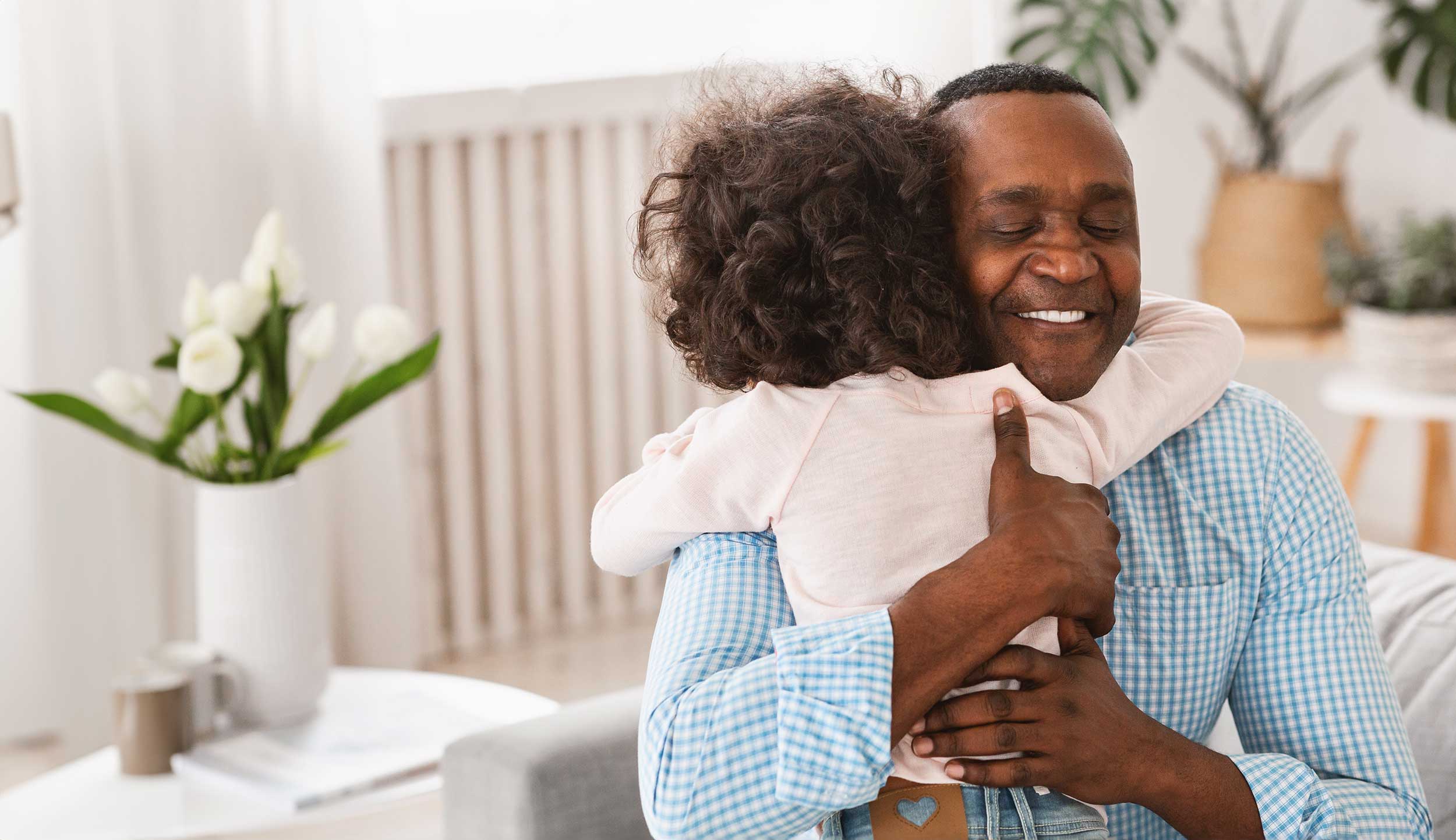 grandfather hugging grandaughter