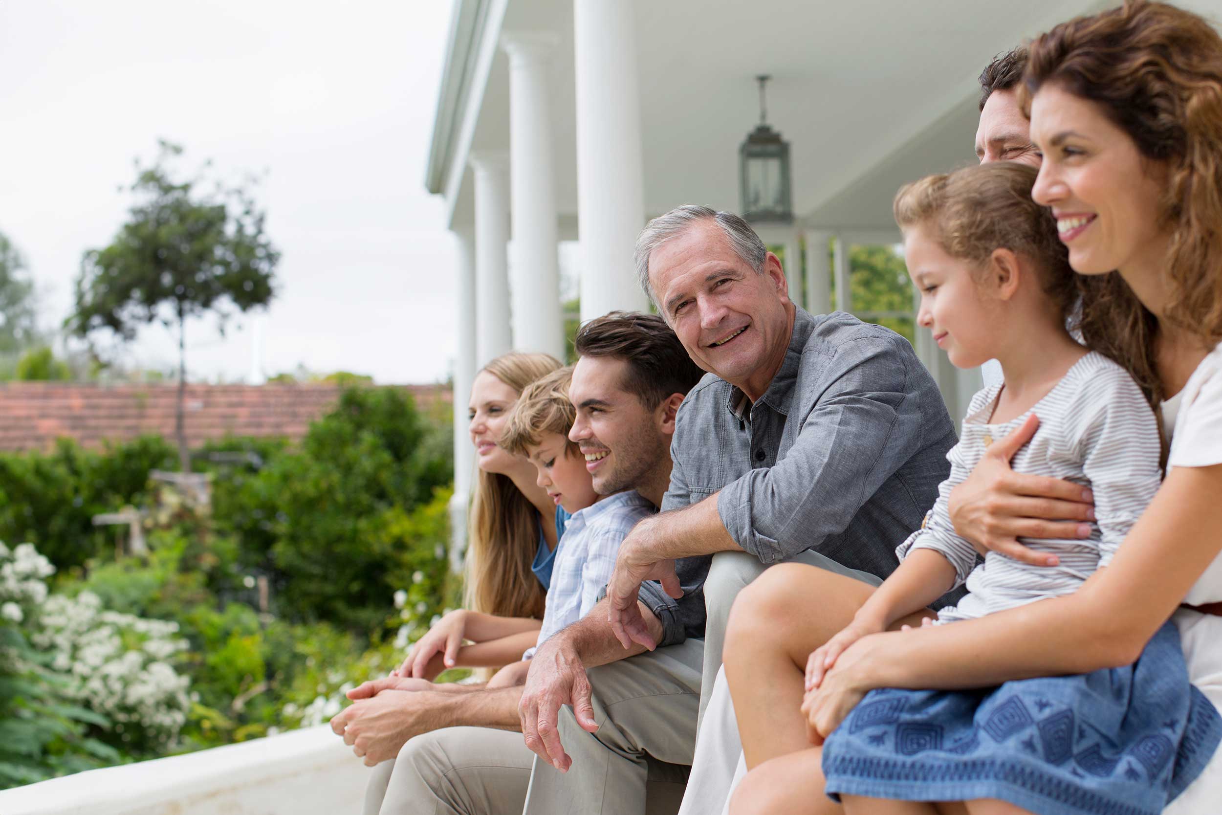 mutli-generational family sitting on a front porch
